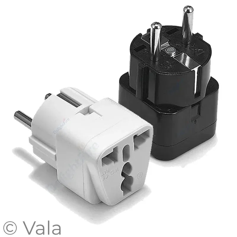White and black travel adapter plugs on a white background
