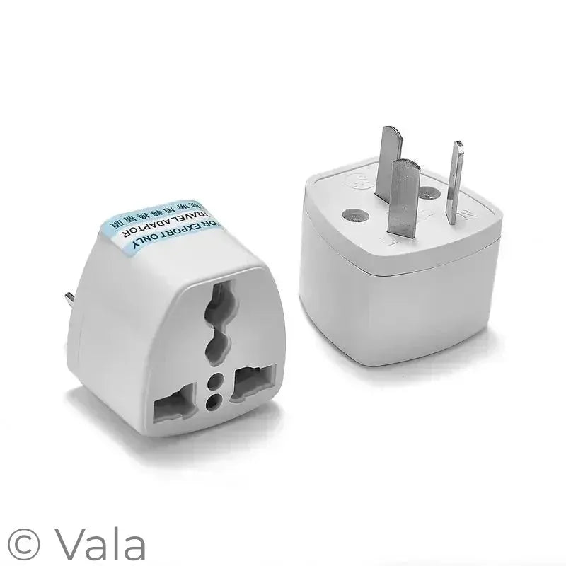 Two travel adapters on a white background