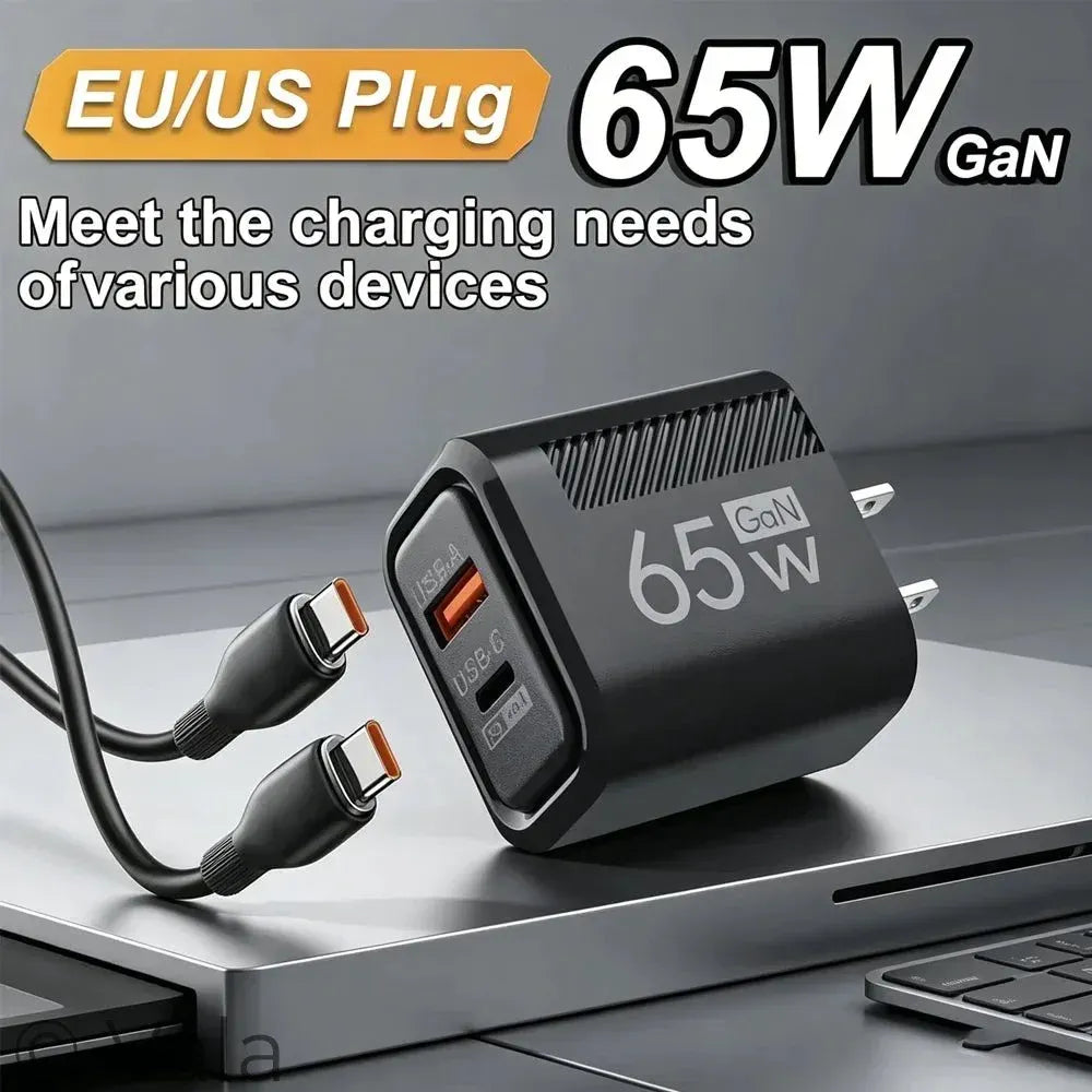 A 65W GaN EU/US plug dual USB-C charger shown on a laptop with two attached cables. The charger is black with white '65W GaN' text and orange USB-C port accents.