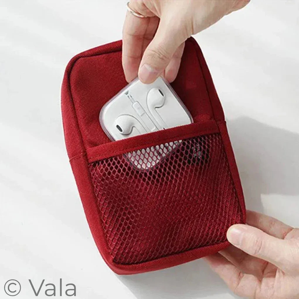 Red pouch with a mesh pocket containing white earbuds, held by a hand on a light gray background.