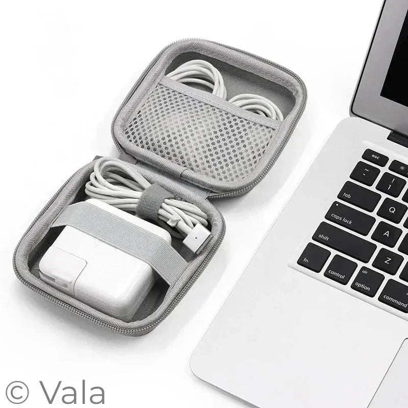 Gray carrying case with electronic accessories next to a laptop