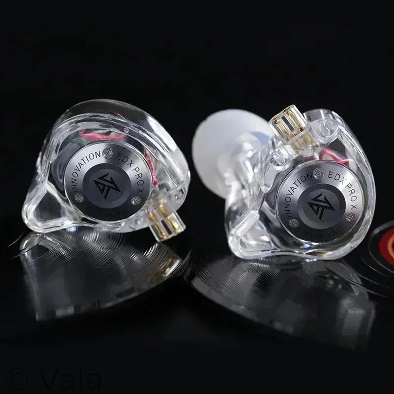 In-ear monitor headphones with clear casings on a dark background