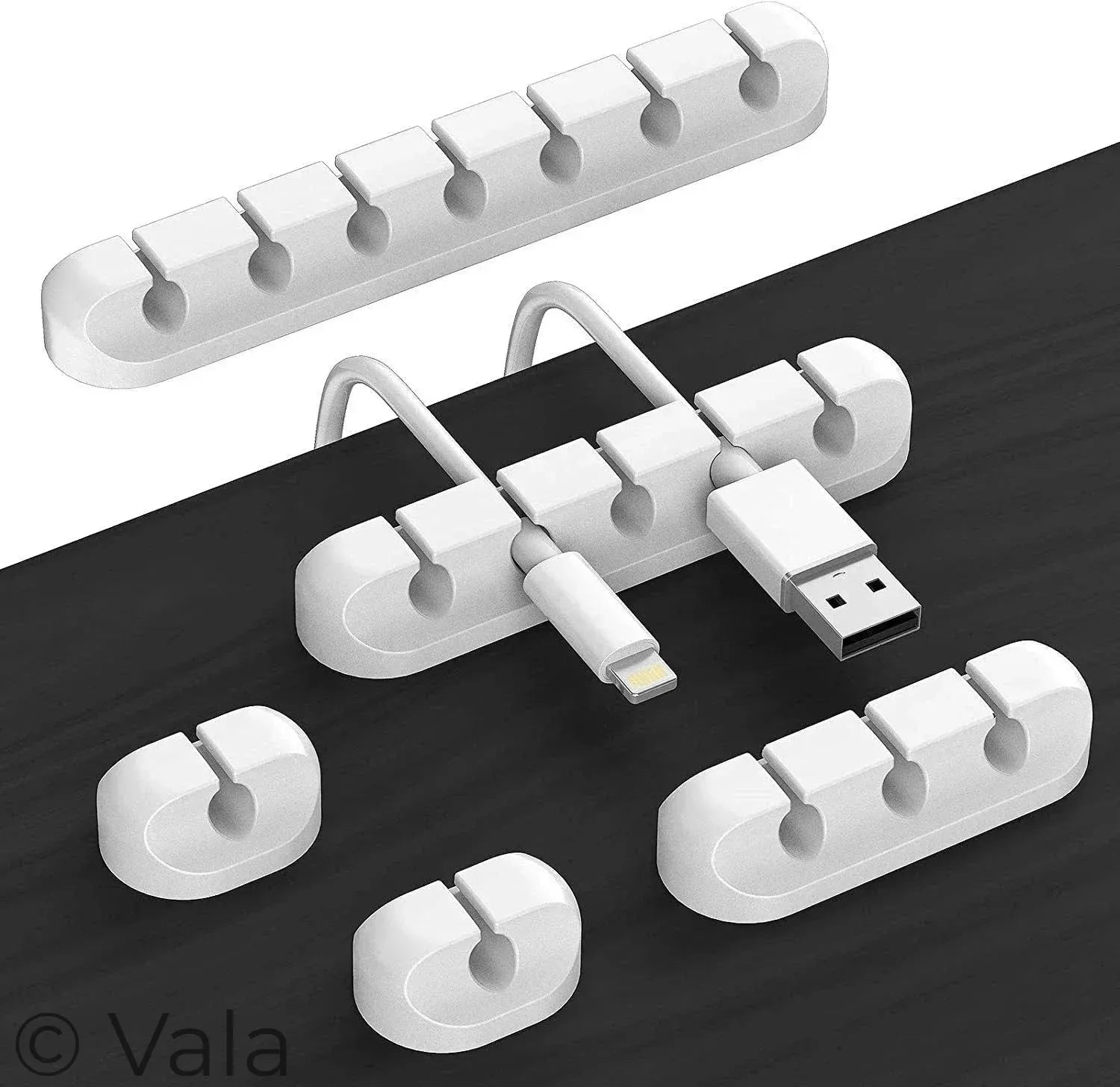 White cable organizer with multiple ports on a dark surface